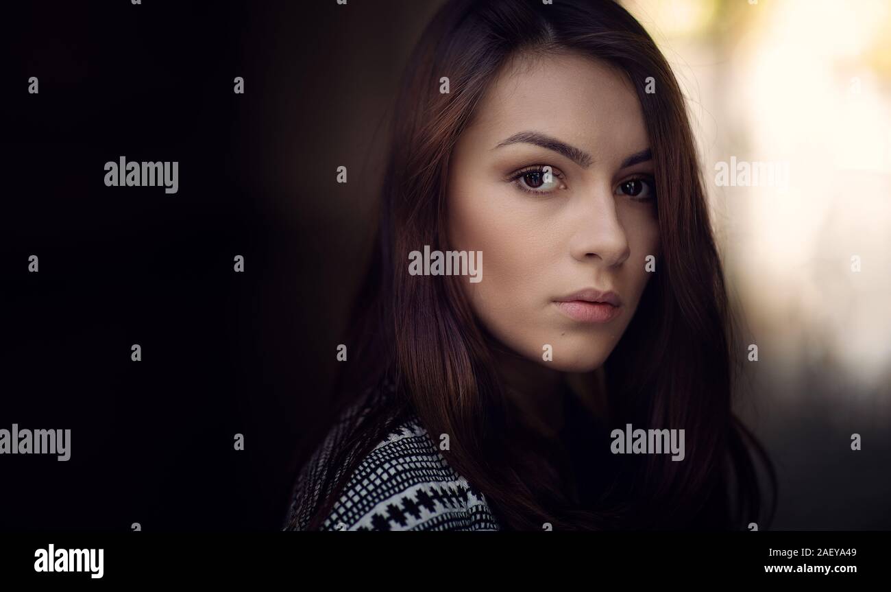 Lonely sad woman deep in thoughts looking behind Stock Photo