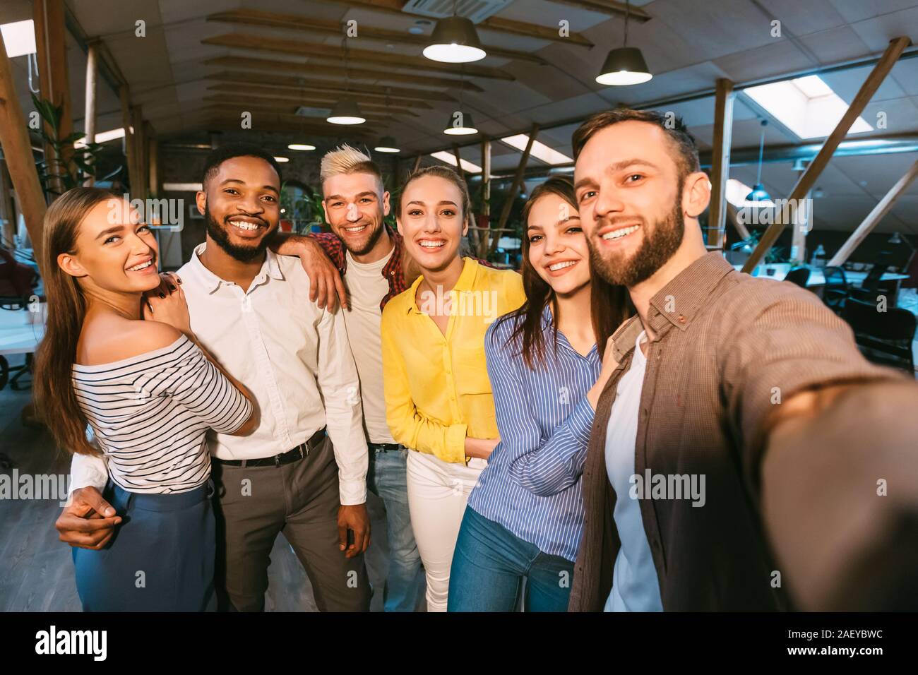 Friendly colleagues taking selfie at coffee break, posing together to camera Stock Photo