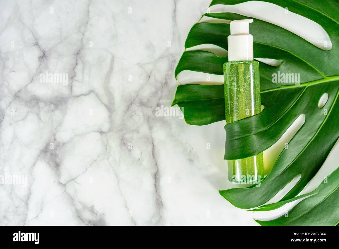 bio cosmetic product on leaf with marble background . Stock Photo