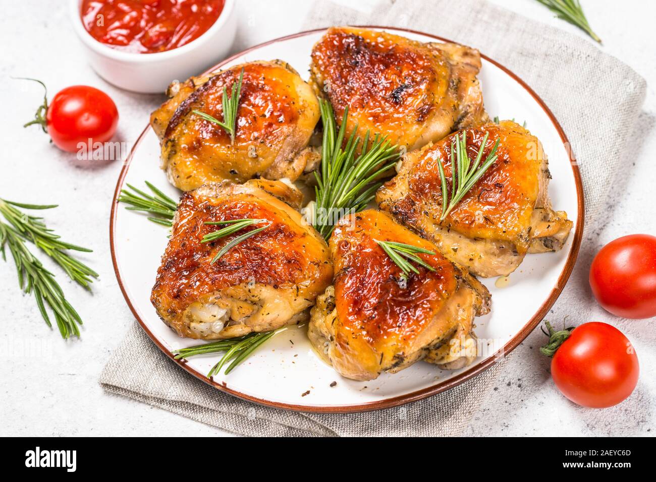 Baked chicken thighs with herbs on white plate Stock Photo Alamy