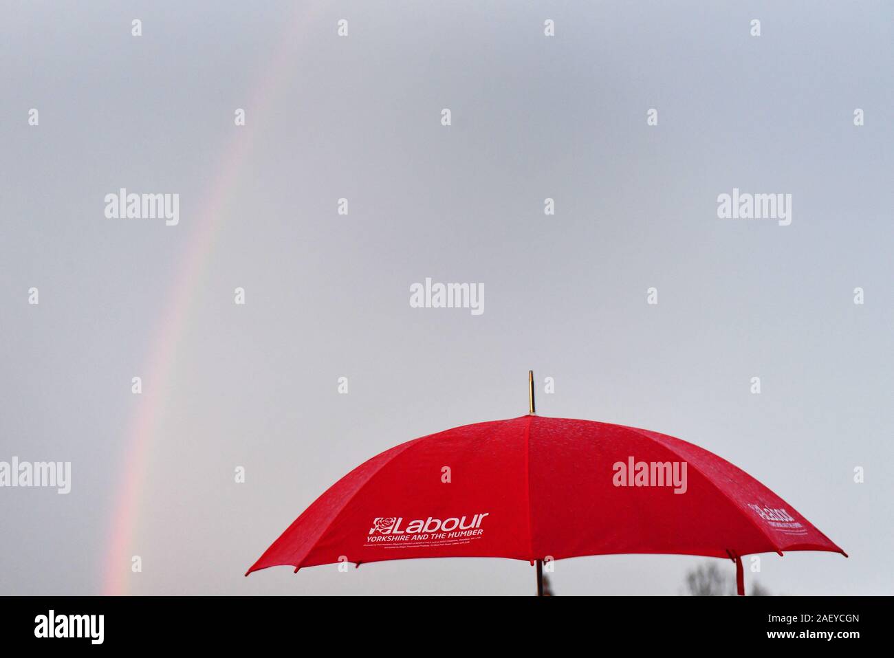 RETRANSMITTED CORRECTING LOCATION AND PHOTOGRAPHER'S BYLINE A Labour supporter holds an umbrella as a rainbow crosses the sky whilst supporters await the arrival of Labour Party leader Jeremy Corbyn to Dinnington, Sheffield, on the last day of General Election campaigning. Stock Photo