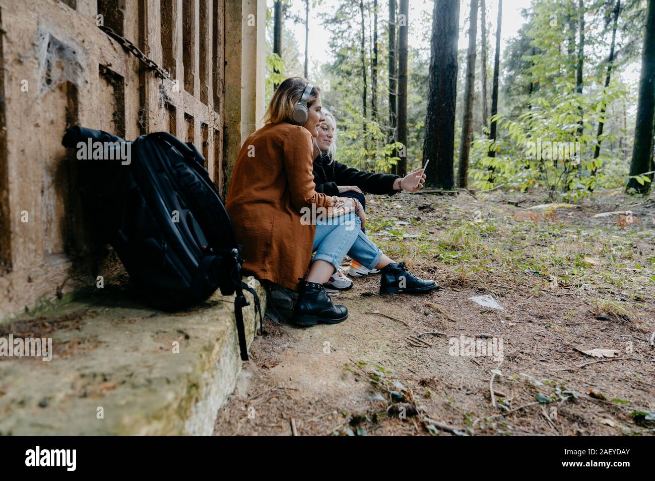 Women streaming video on their smartphone in a remote forest Stock Photo