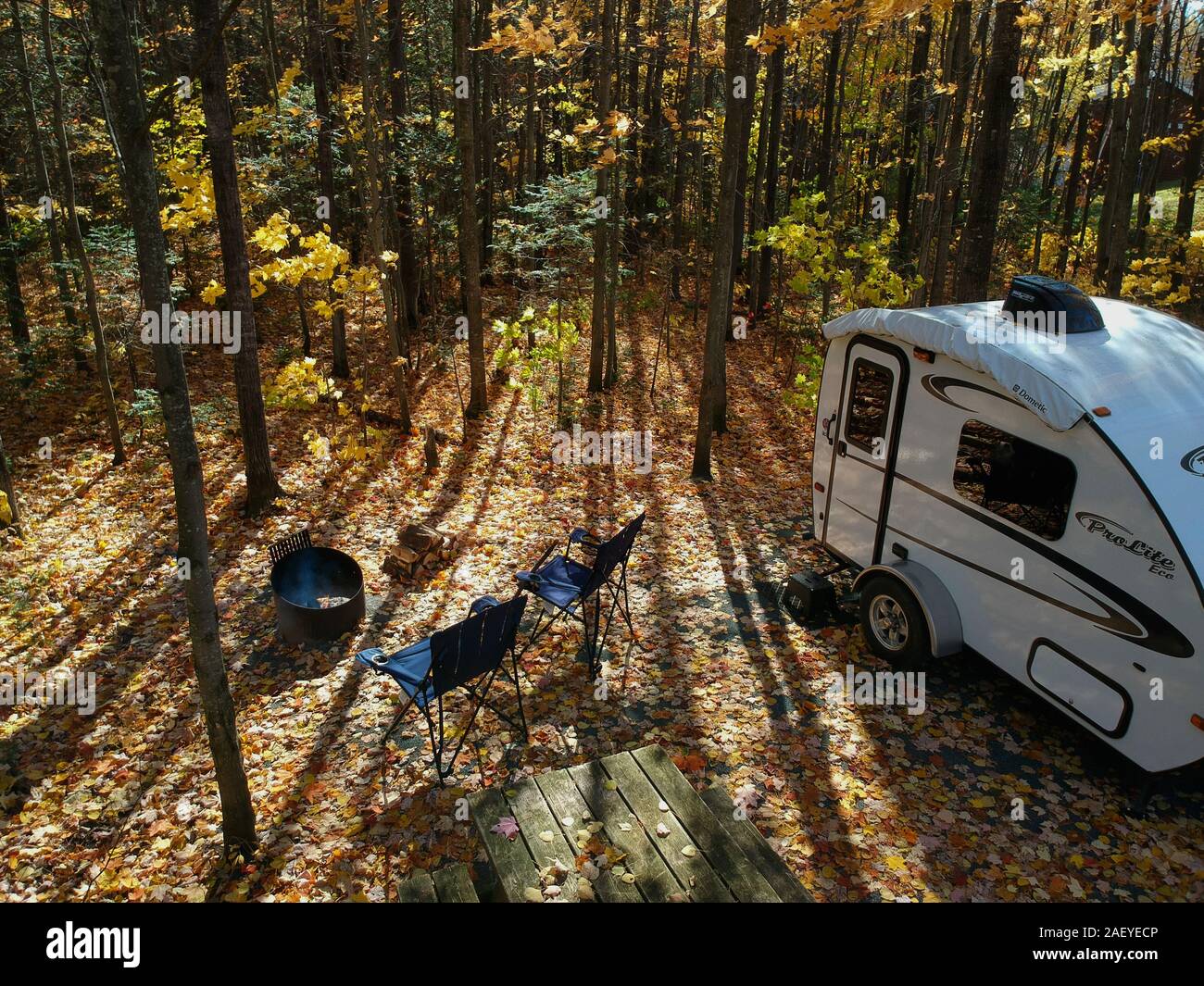 October 15, 2019 - Centre-du-Québec, Canada: Aerial view of a Prolite Travel trailer on campsite surrounded by Autumn foliage, Canadian RVing Stock Photo