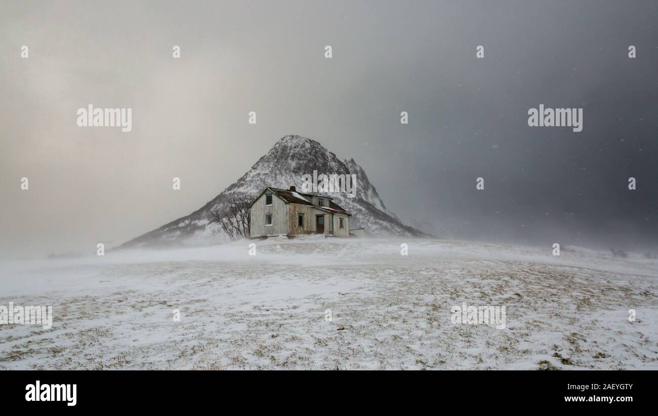 Protection from the Elements.  A lonely house in the Lofoten Islands in the hands of the forces of nature Stock Photo