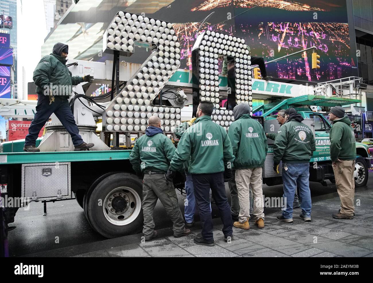 New York, United States. 11th Dec, 2019. Workers surround the two and zero of the 2020 New Year's Eve Numerals when they arrive in Times Square in New York City on Wednesday, December 11, 2019. The giant, seven-foot-tall '20' arrived on a flatbed truck on 46th Street and Broadway and will be brought to the top of One Times Square where they will rest for a few days before completing the '2-0C2-0' sign that lights up at midnight on New Year's Eve to announce the beginning of the New Year at the completion of the Ball Drop. Photo by John Angelillo/UPI Credit: UPI/Alamy Live News Stock Photo