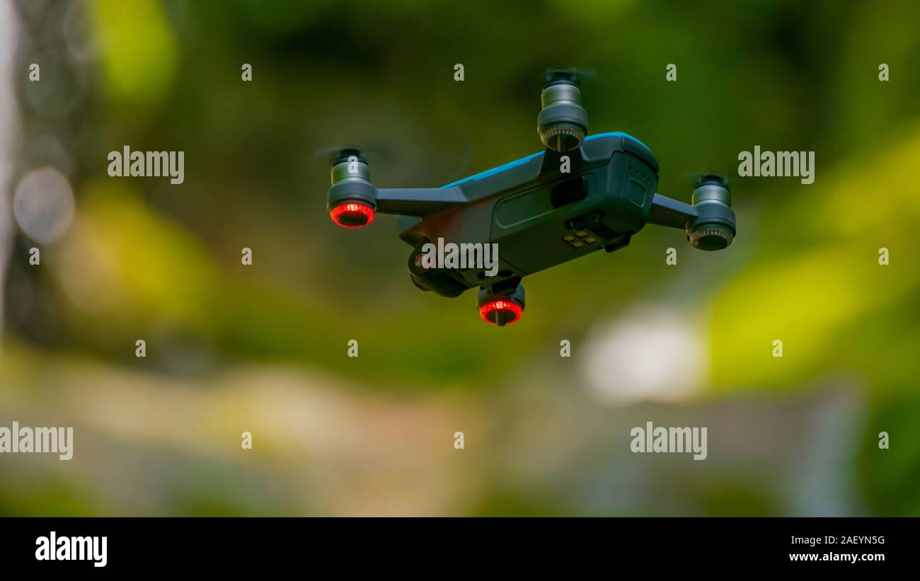flying drones on green background blurred Stock Photo