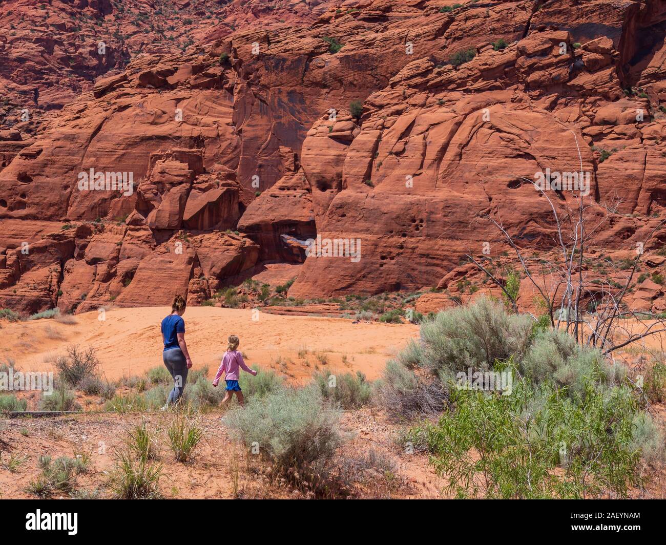 Mother and daughter walk past the dunes, Snow Canyon State Park, Saint ...