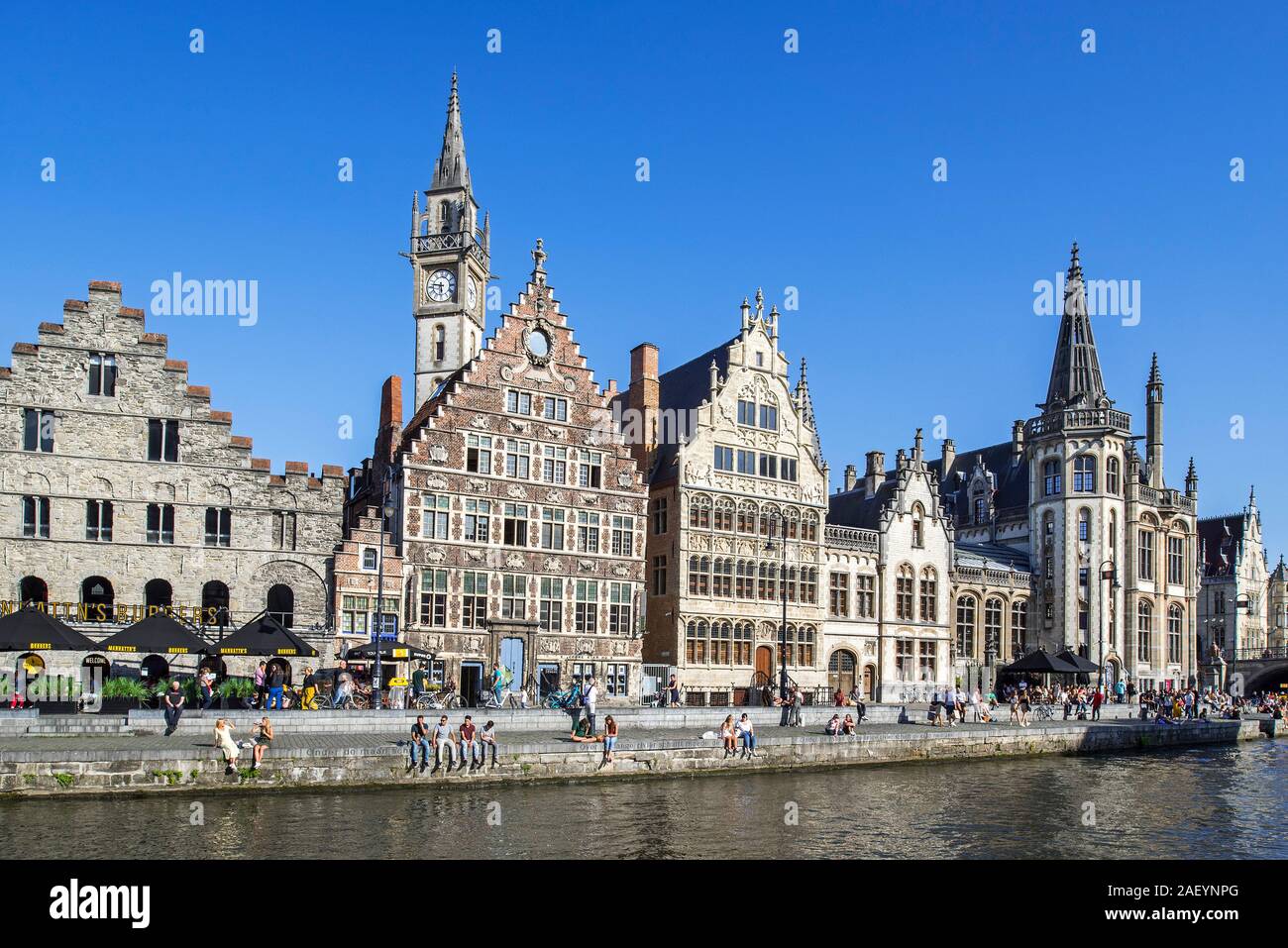 Tourists on quay along the river Lys / Leie and view over medieval guildhalls at the Graslei / Grass Lane in the city Ghent, East Flanders, Belgium Stock Photo