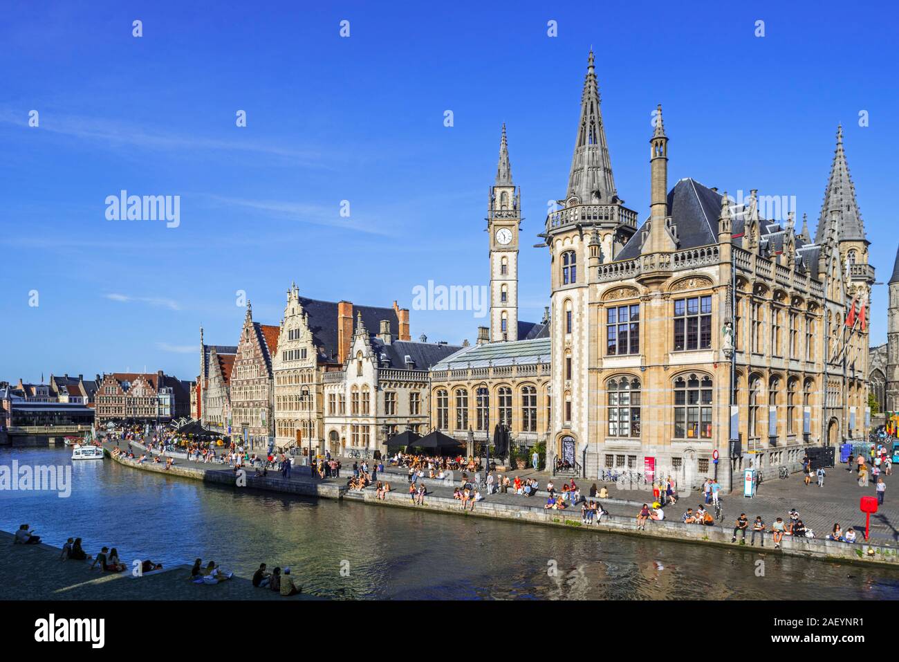 Tourists on quay along the river Lys / Leie and view over medieval guildhalls at the Graslei / Grass Lane in the city Ghent, East Flanders, Belgium Stock Photo