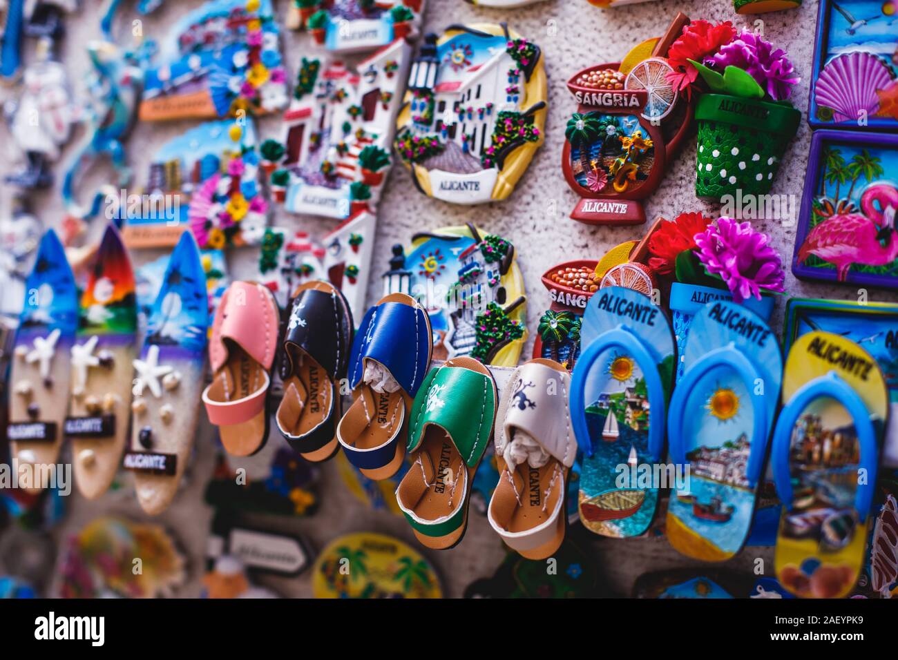 View of traditional tourist souvenirs and gifts from Spain, Alicante, Valencia with toys, bull figures, flamenco dancer dolls, fridge magnets with and Stock Photo