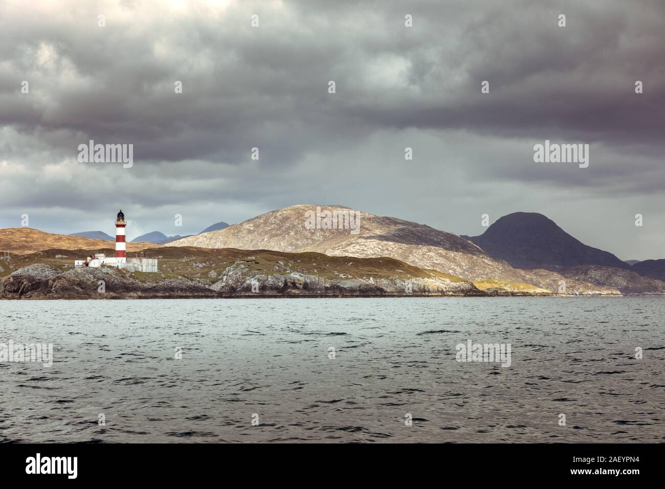 Eilean Glas Lighthouse off Scalpay with mountains of the Park (Pairc) area of Lewis in the background Stock Photo