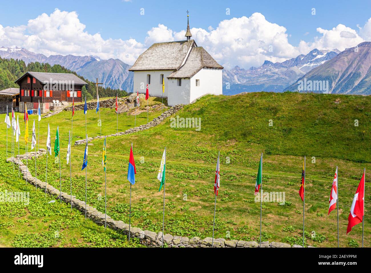 Bettmeralp church and flags in the Swiss Alps, Valais, Switzerland Stock Photo