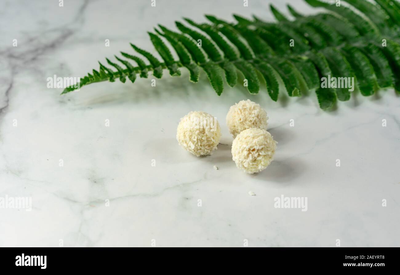 Bio healthy natural coco balls dessert with leaf and marbel background . Stock Photo