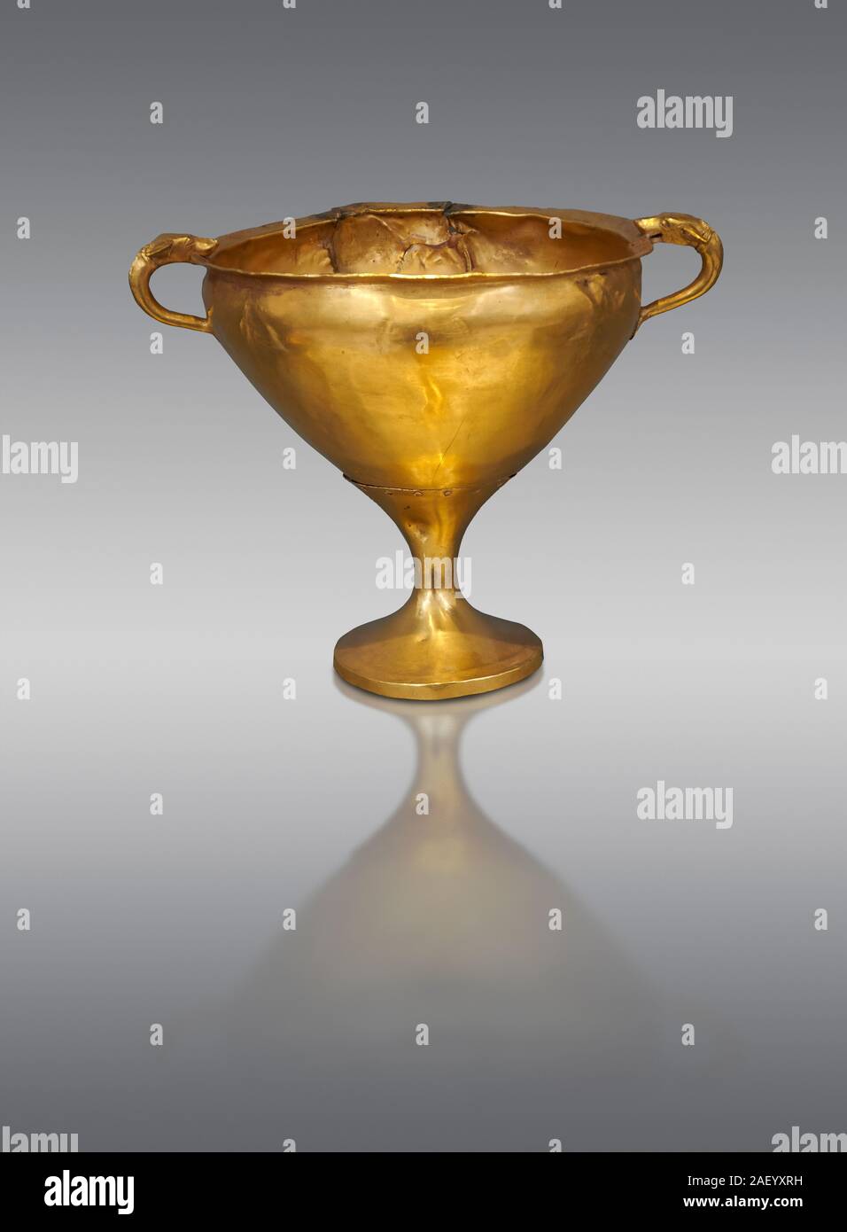 Mycenaean gold goblet with two handles ening with a dogs head