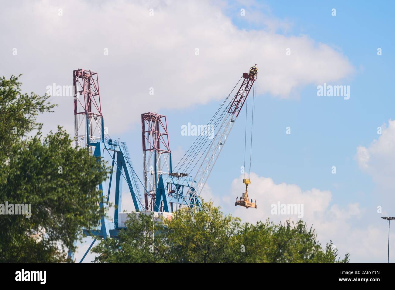 Mobile, USA - April 21, 2018: Industrial factory in Alabama with warehouse business shipping containers with cranes isolated against sky Stock Photo