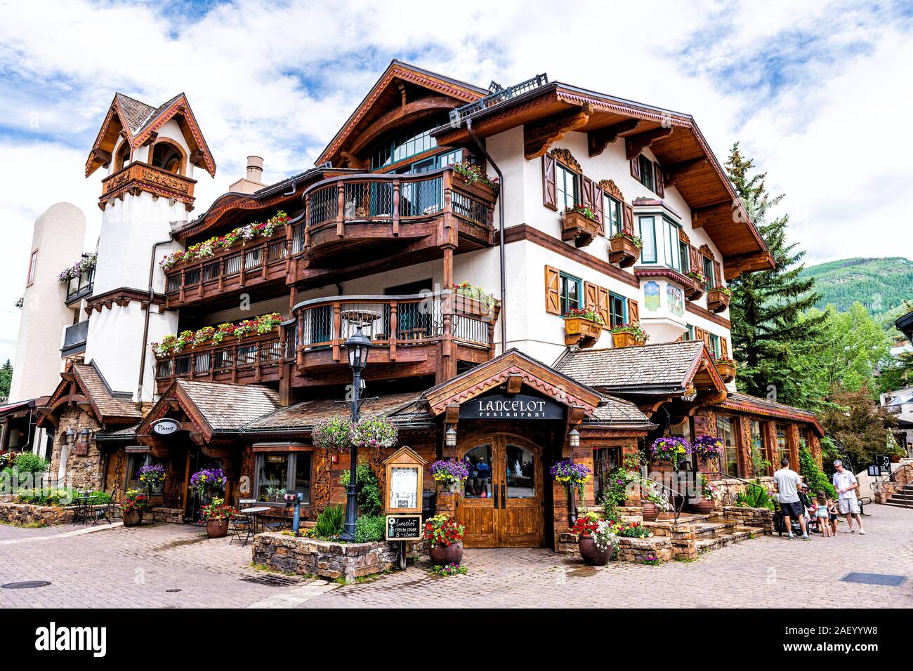 Vail, USA - June 29, 2019: Swiss style resort town in Colorado with wide angle view of Lancelot restaurant shop on Gore Creek drive Stock Photo