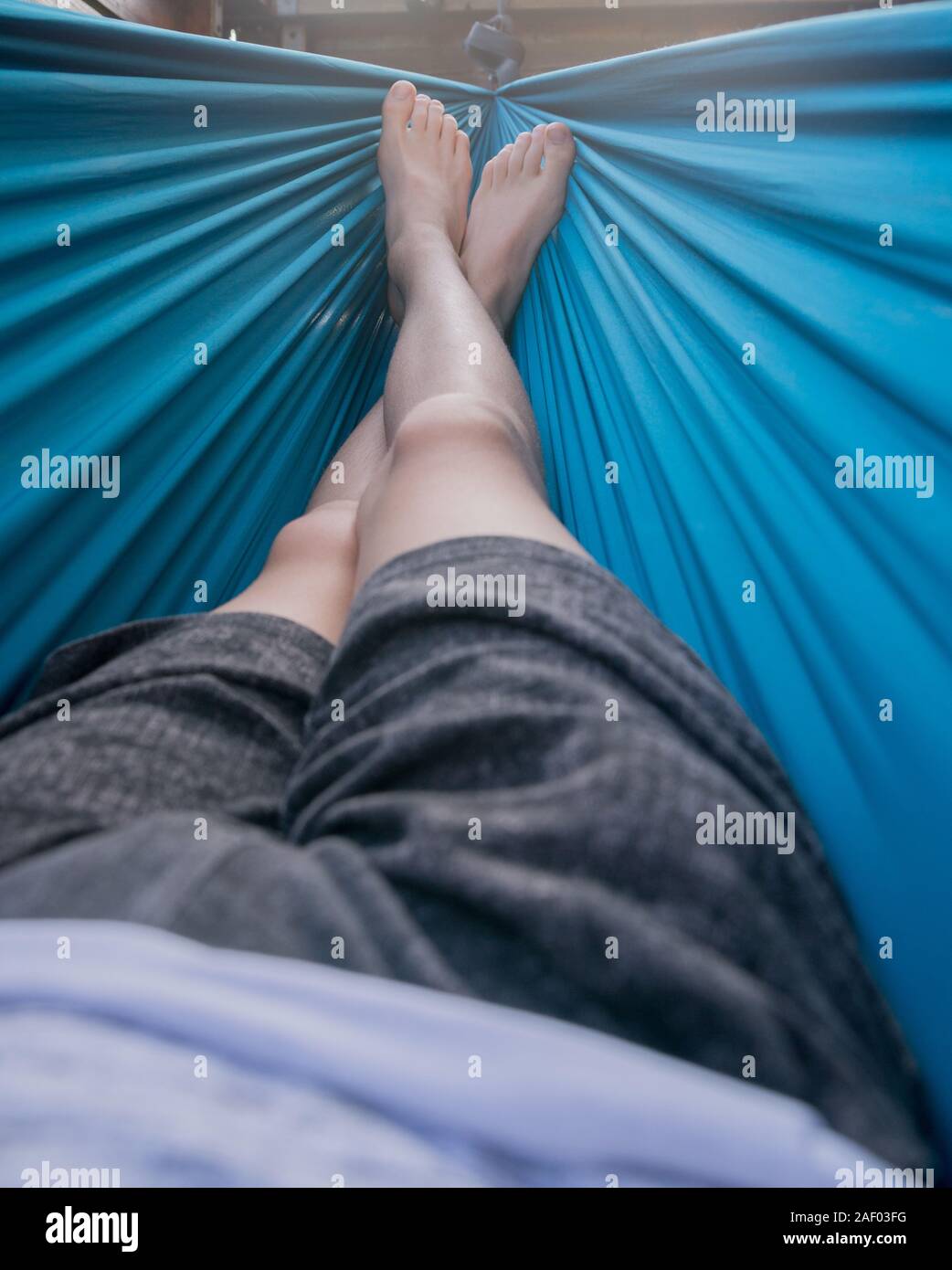 Man lying in a hammock Stock Photo