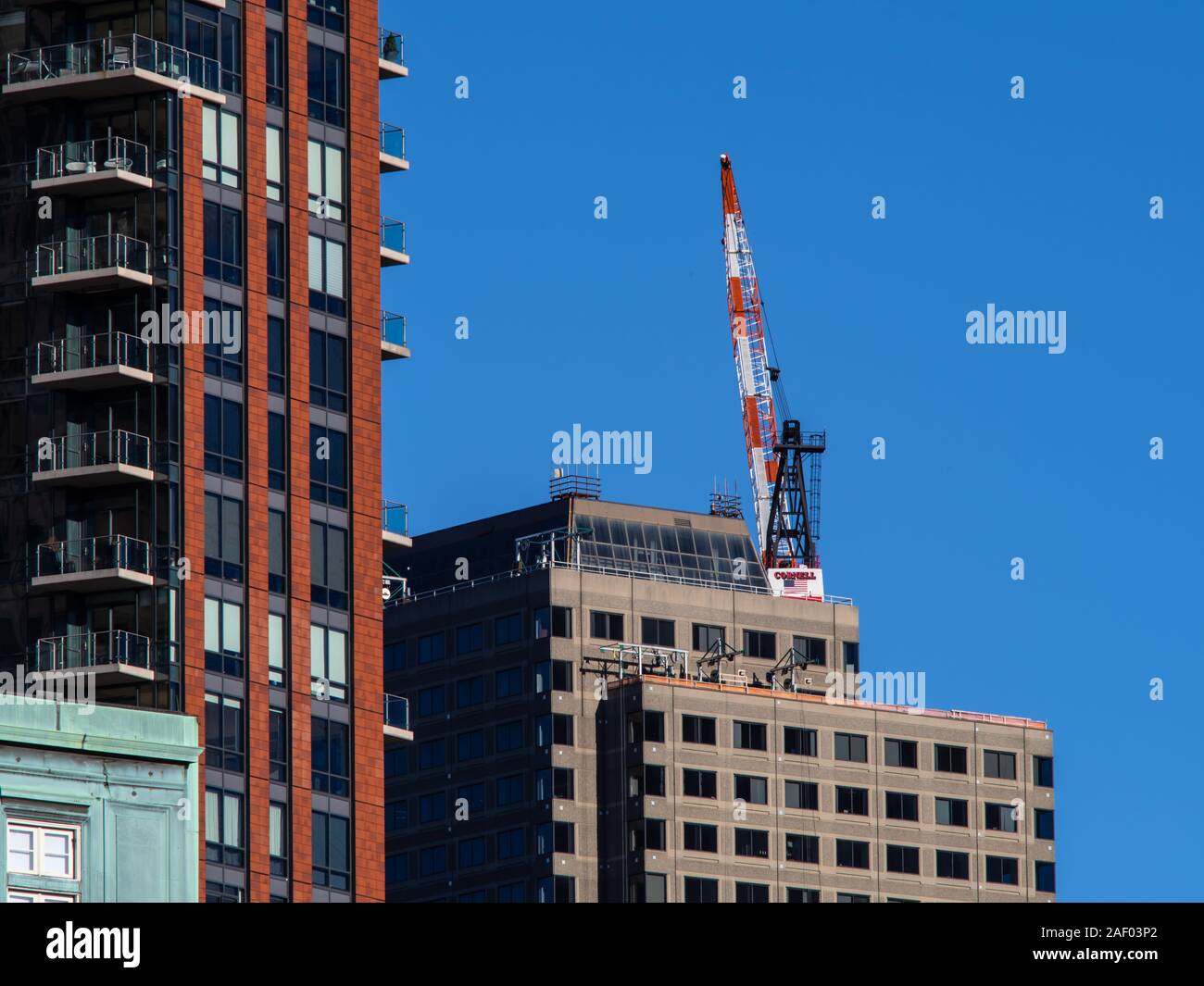 A Crane sits atop a skyscraper in downtown Boston Stock Photo