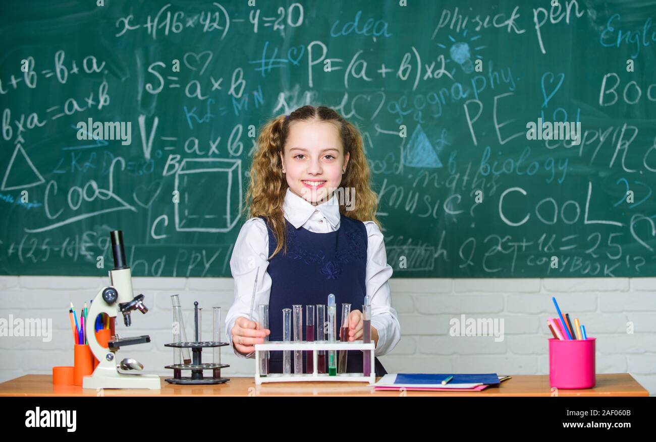 student doing biology experiments with microscope. Little child at school lesson. Chemistry. Back to school. childrens day. Little girl learning chemistry in school lab. She need an expert advice. Stock Photo