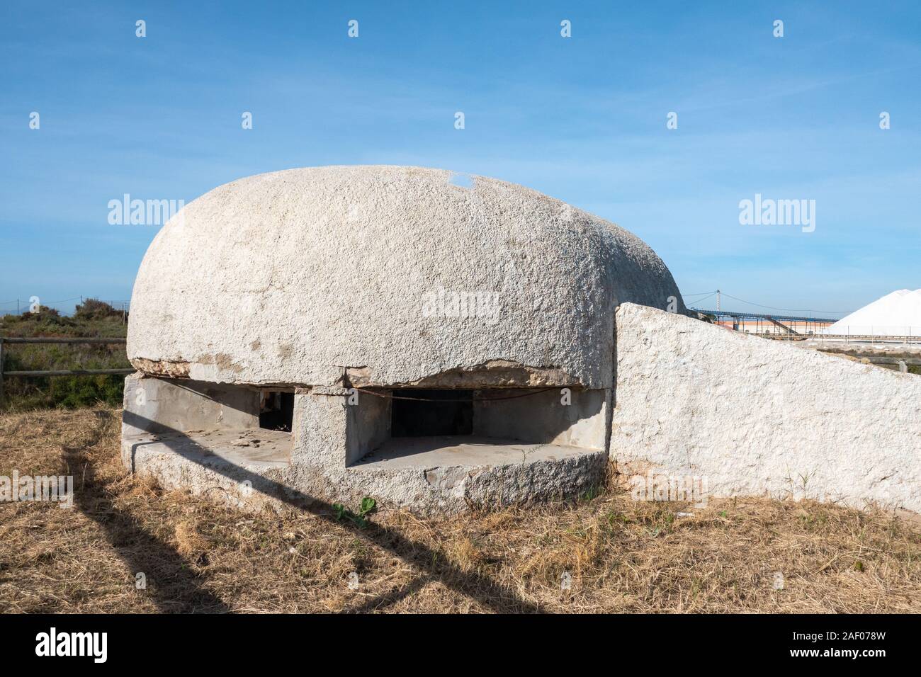 Bunkers from the Spanish Civil War in the dunes of the Playa de La Gola,Santa Pola, Aicante Province, with sea salt mountains in the background Stock Photo