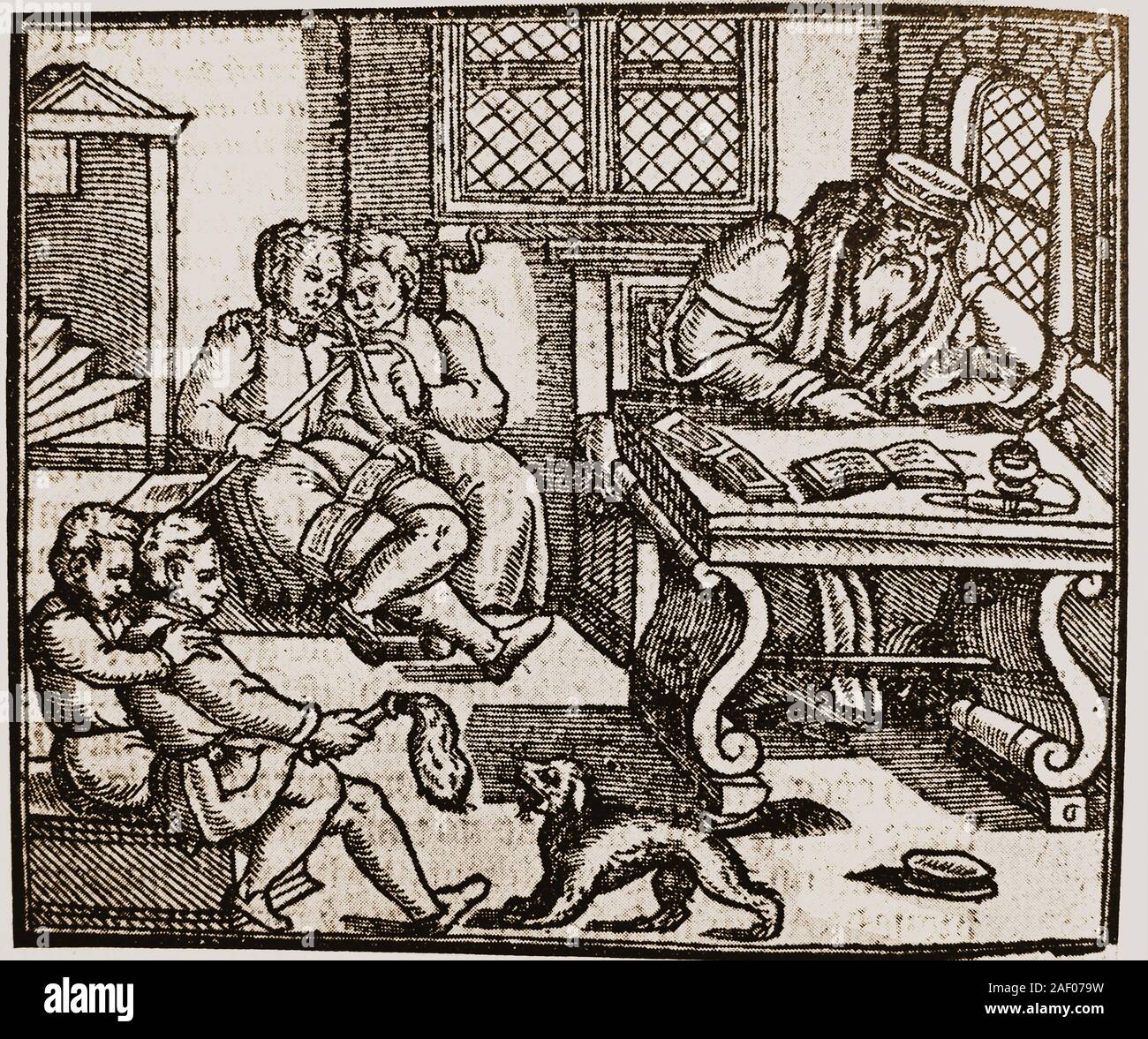 An historic woodcut showing the interior of a Tudor School room showing the teacher and pupils, some of which are playing  with a pet dog apparently without concern to the schoolmaster. There were two  main types of official schools in Tudor times,Grammar Schools which taught boys Latin; and Petty Schools which taught boys aged 4-7   (similar to our infant schools). Most were fee paying and were often run by monasteries. Few girls received a full education. Stock Photo