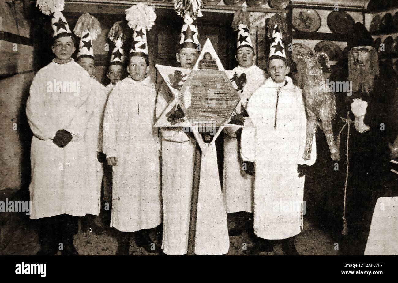 1940's  Swedish Christmas  custom - STARBOYS (Star King is centre - Judas dressed in black) - Saint Lucy's Day  aka Feast of Saint Lucy, is signals the arrival of Christmastide, and the  arrival of the Light of Christ in the calendar, on Christmas Day Stock Photo