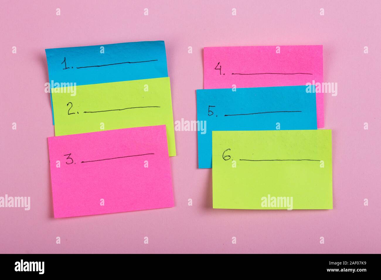 Plan of the week on colored blank stickers on pink background Stock Photo
