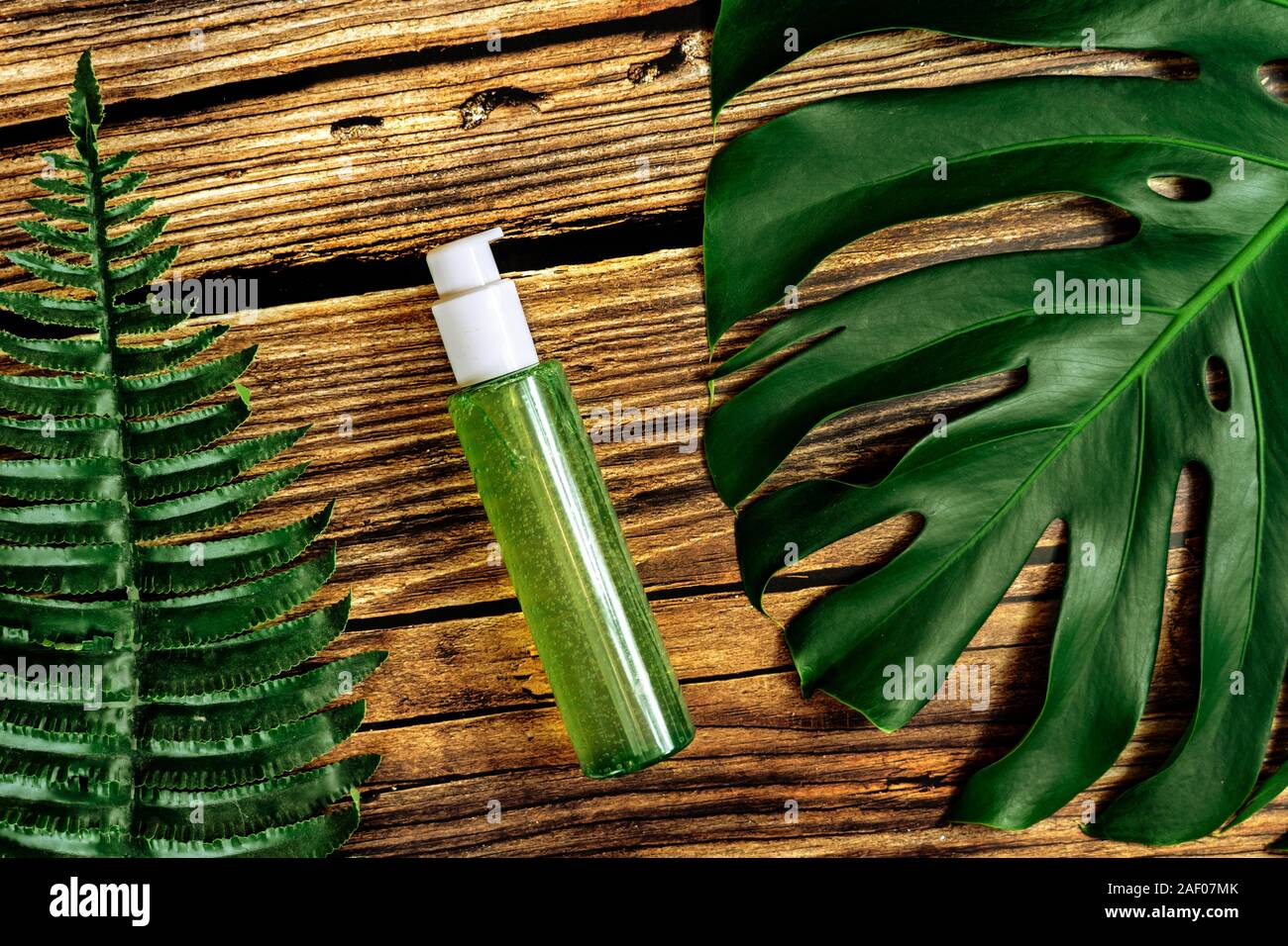 bio cosmetic product on rustic wooden background with leaves . Stock Photo