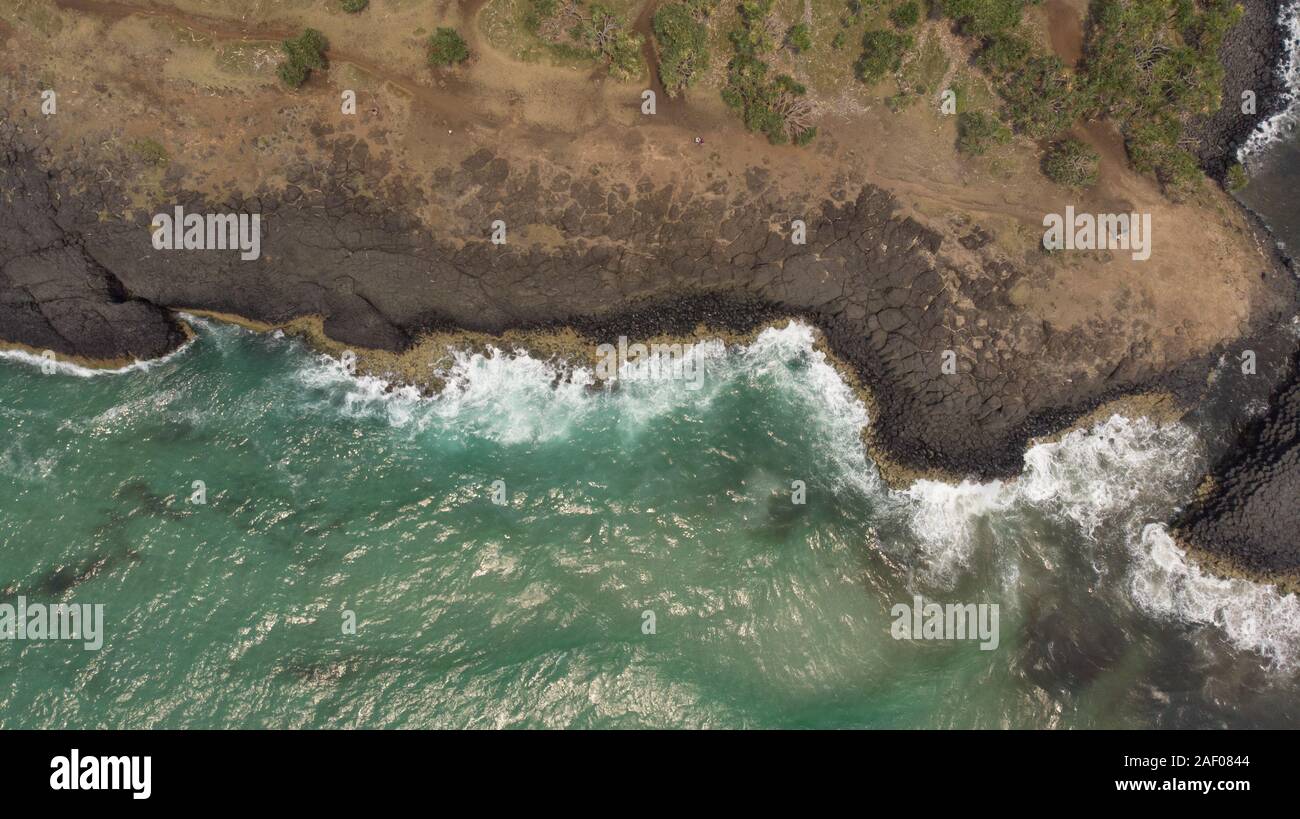 Aerial Top View Photo Background from Flying Drone Above Rock waves Sea Water Stock Photo
