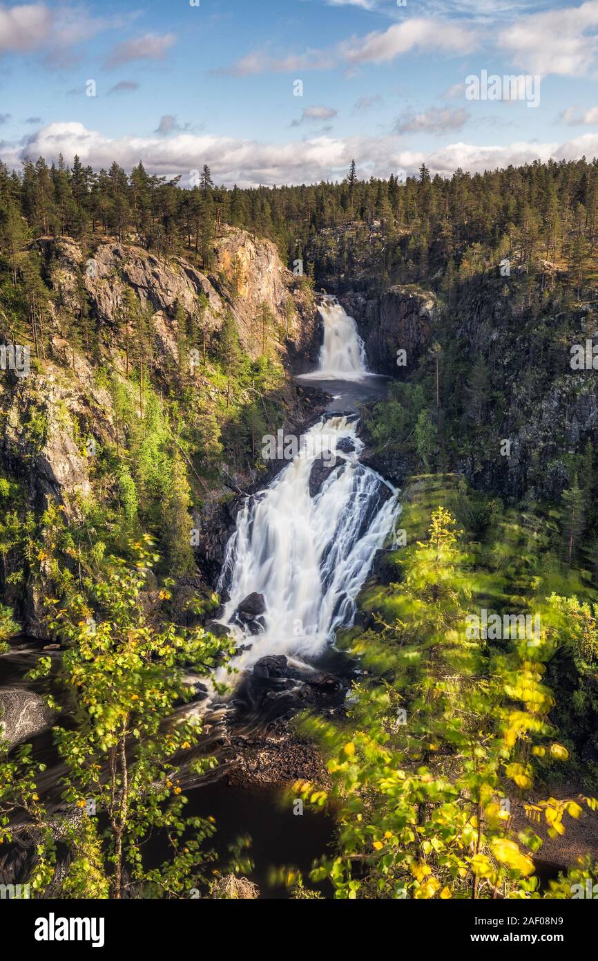 Waterfall and pines surrounded by the mountains of the Muddus national park, Norrbotten County, Swedish Lapland Stock Photo