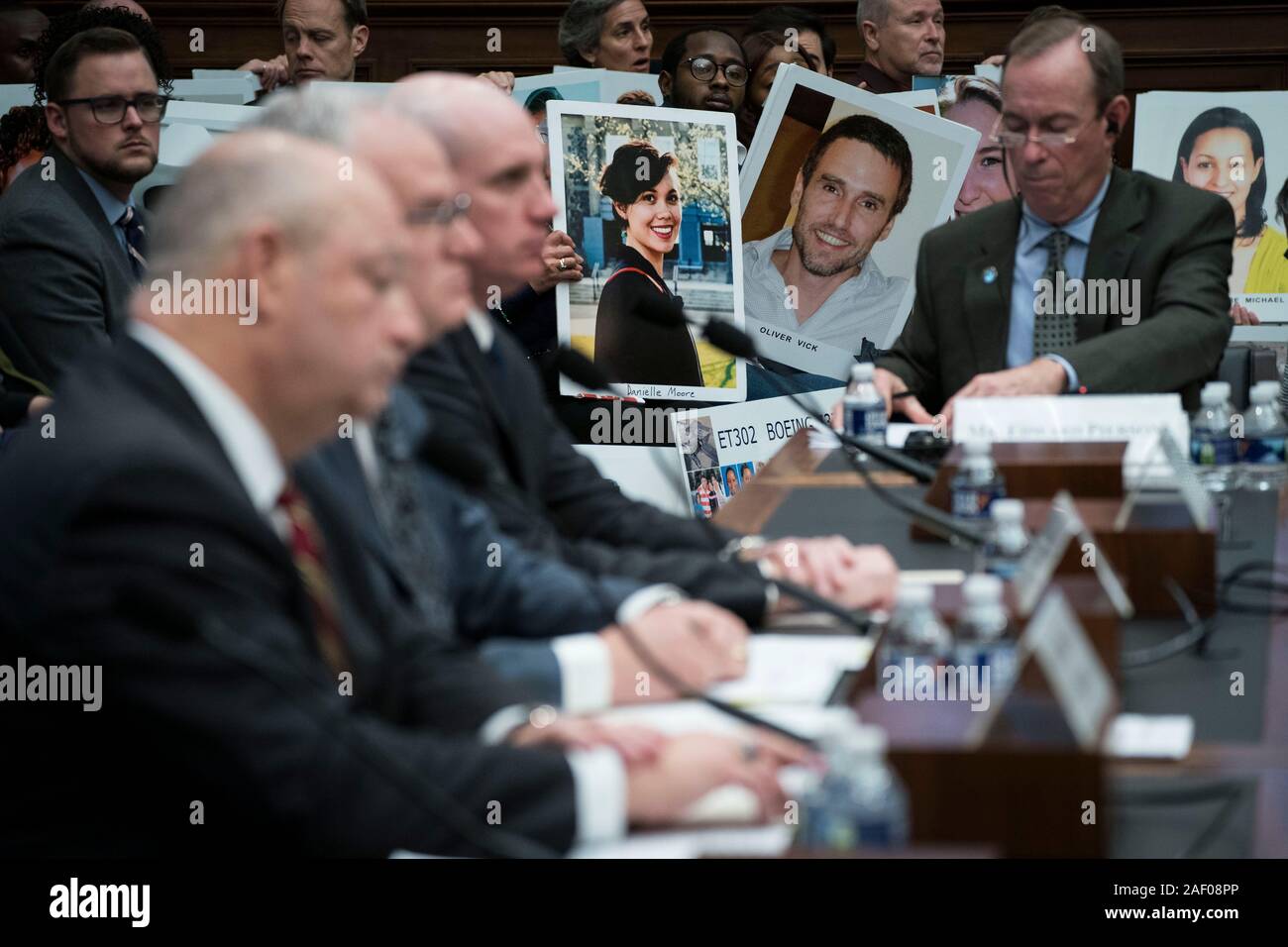 (191211) -- WASHINGTON, Dec. 11, 2019 (Xinhua) -- People hold photos of Boeing 737 plane crash victims as Stephen Dickson, chief of the Federal Aviation Administration (FAA), testifies before the House Committee on Transportation and Infrastructure during a hearing on 'The Boeing 737 MAX: Examining the Federal Aviation Administration's Oversight of the Aircraft's Certification' in Washington, DC, the United States, on Dec. 11, 2019. Steve Dickson said Wednesday that aviation regulators won't likely clear Boeing's troubled 737 Max airplanes for flight until 2020. (Photo by Sarah Silbiger/Xinhu Stock Photo