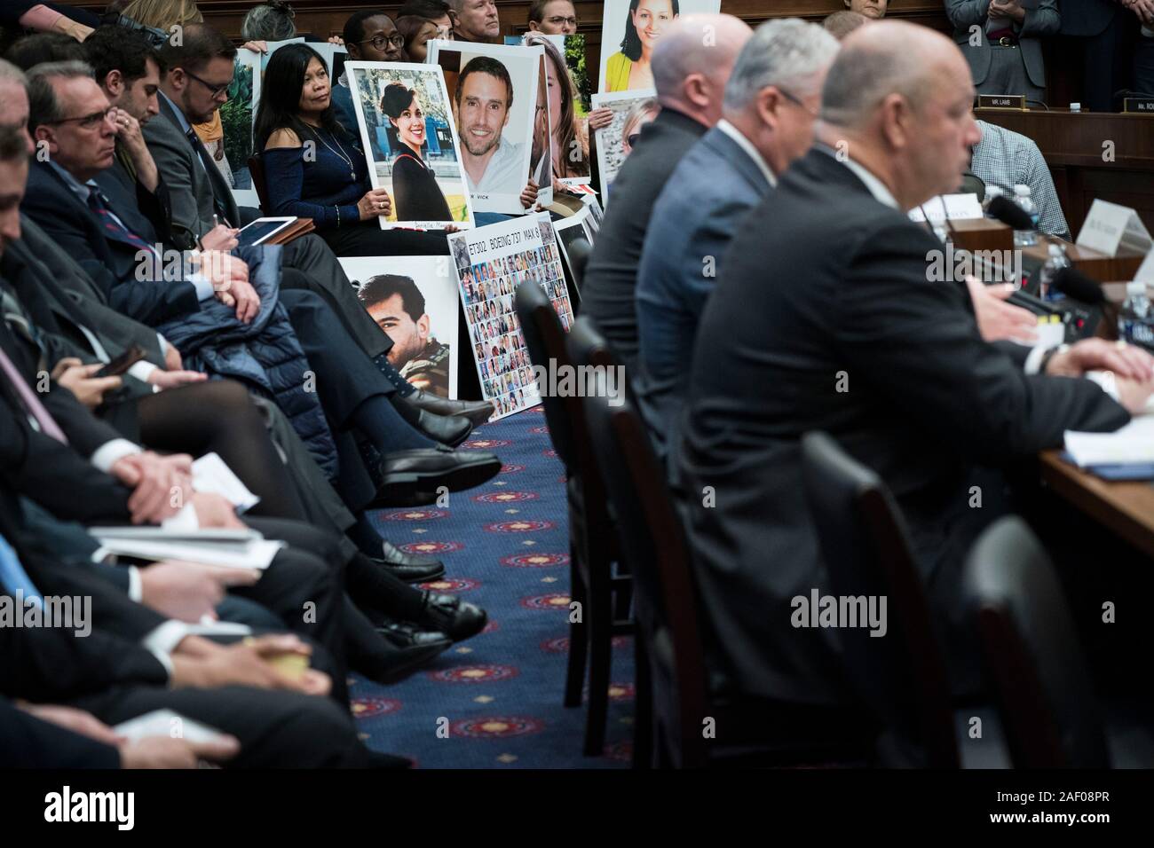 (191211) -- WASHINGTON, Dec. 11, 2019 (Xinhua) -- People hold photos of Boeing 737 plane crash victims as Stephen Dickson, chief of the Federal Aviation Administration (FAA), testifies before the House Committee on Transportation and Infrastructure during a hearing on 'The Boeing 737 MAX: Examining the Federal Aviation Administration's Oversight of the Aircraft's Certification' in Washington, DC, the United States, on Dec. 11, 2019. Steve Dickson said Wednesday that aviation regulators won't likely clear Boeing's troubled 737 Max airplanes for flight until 2020. (Photo by Sarah Silbiger/Xinhu Stock Photo