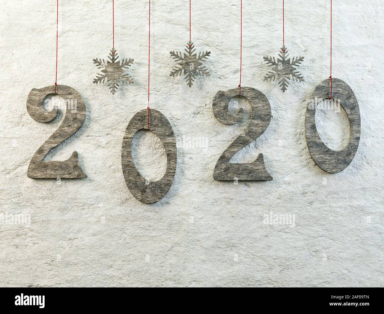 Wooden cut-out 2020 New Year date hanging against the wall on red strings Stock Photo