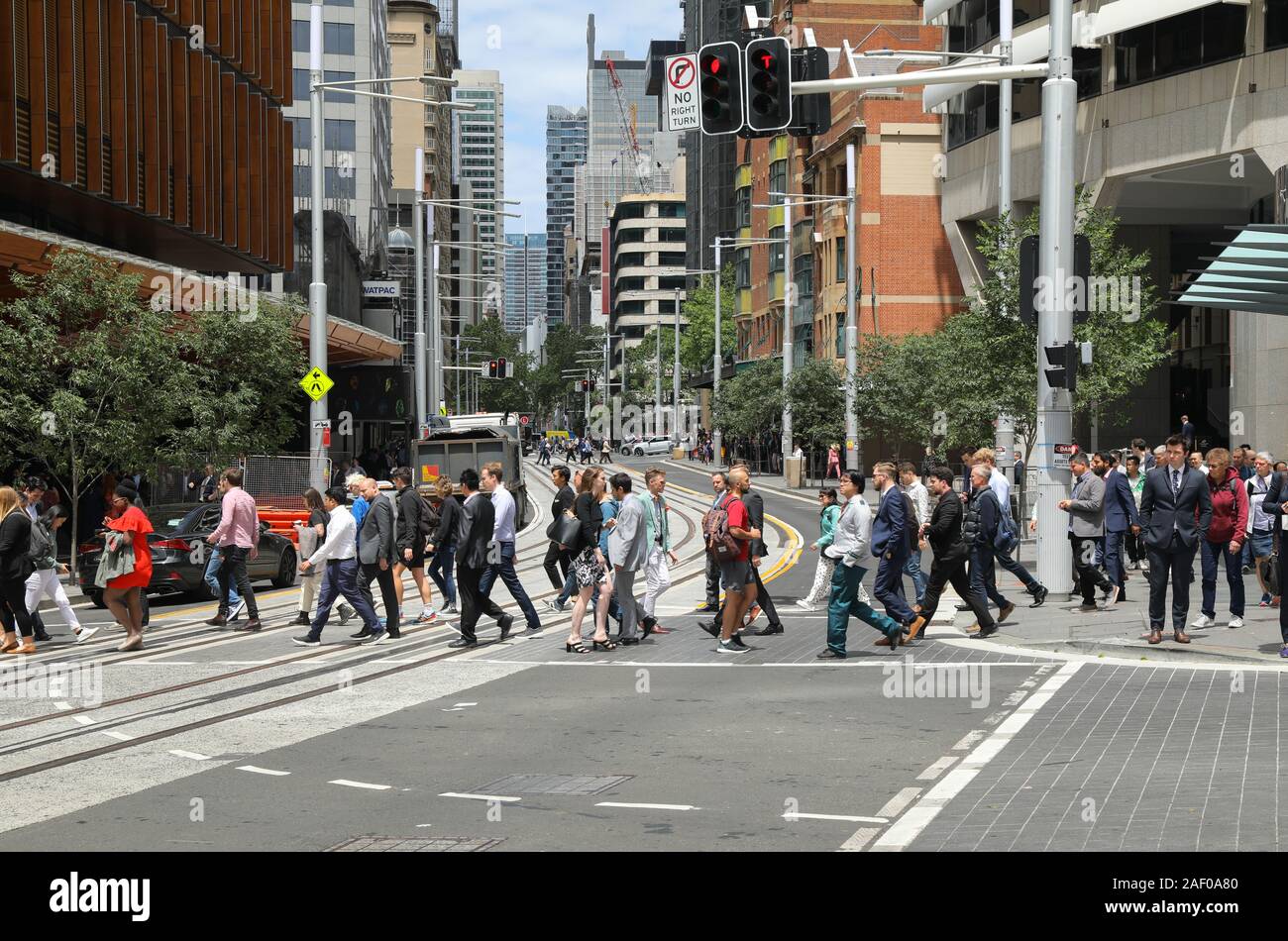 Pedestrians crossing George Street, Sydney Australia, at the junction with Essex Street. Stock Photo