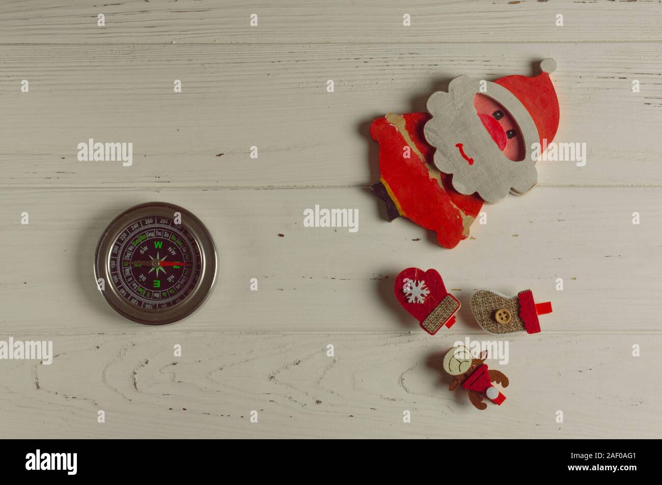 compass points where Santa lives: compass and christmas figurines are on white background Stock Photo