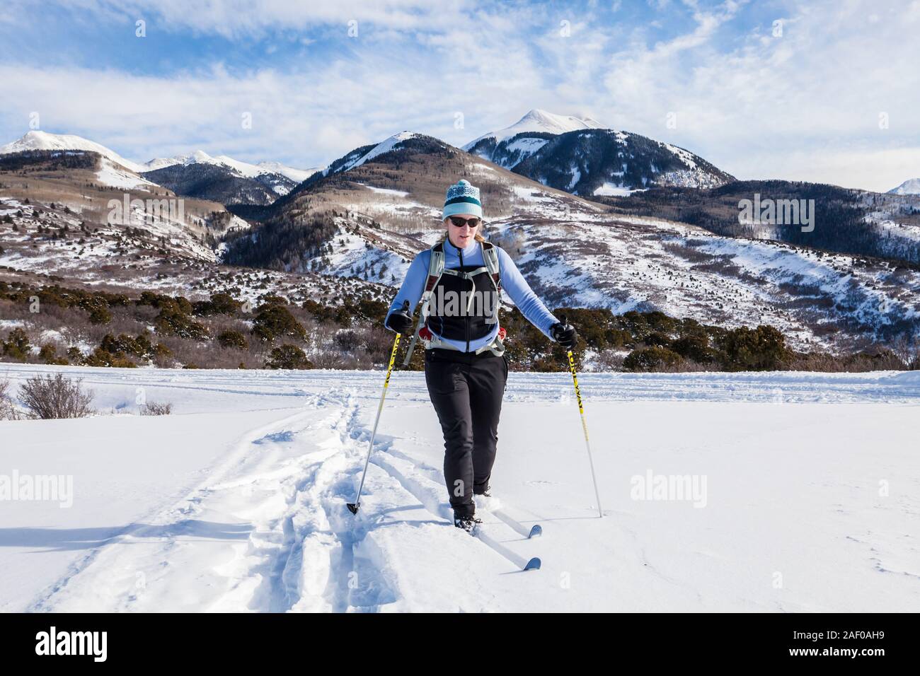 A middle aged woman cross country skiing on the foothills of the La Sal Mountains in southeast Utah, USA. Stock Photo