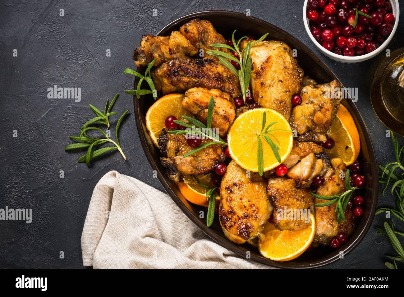 Baked chicken with orange, cranberry and rosemary Stock Photo - Alamy