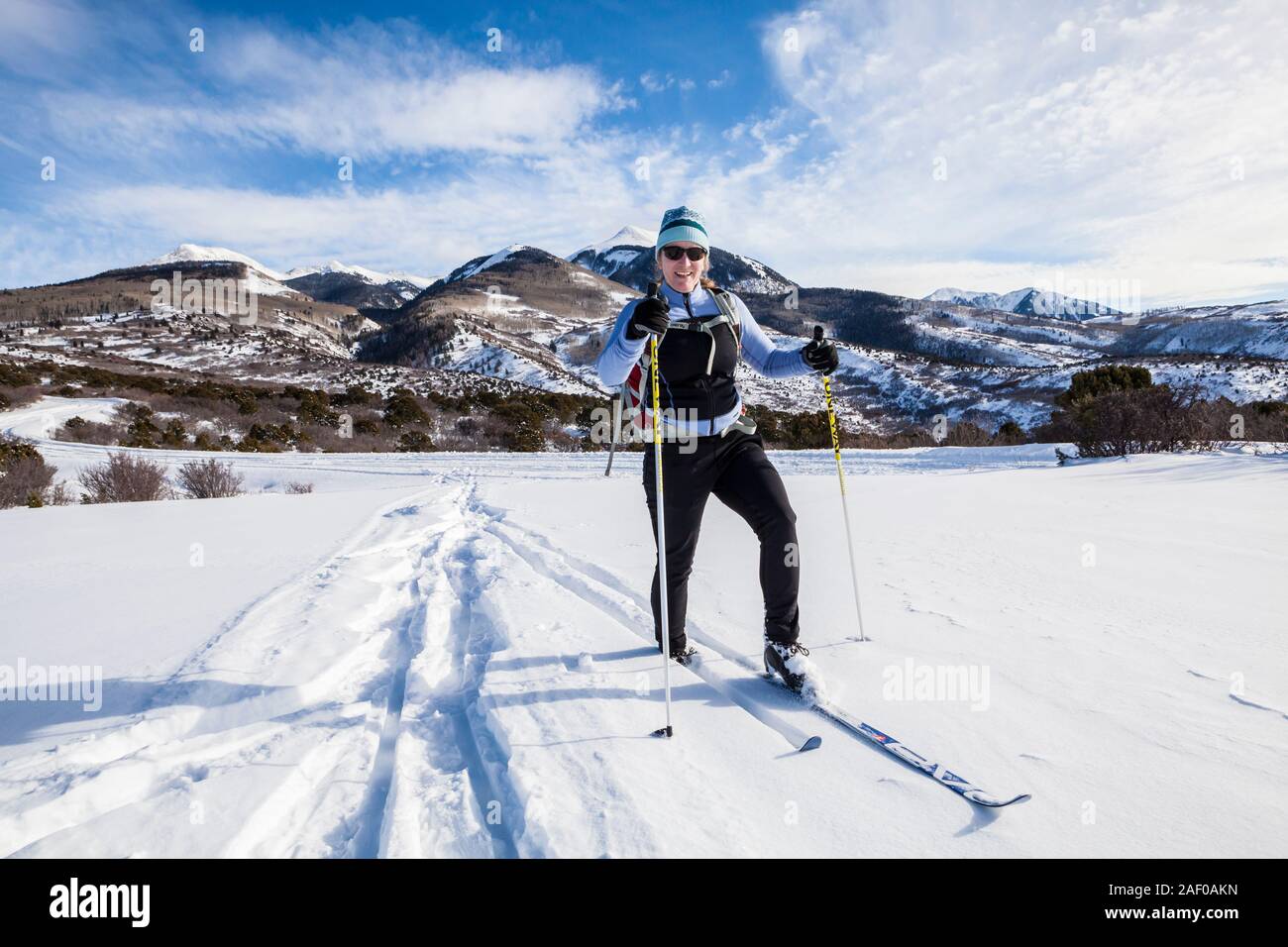 A middle aged woman cross country skiing on the foothills of the La Sal Mountains in southeast Utah, USA. Stock Photo