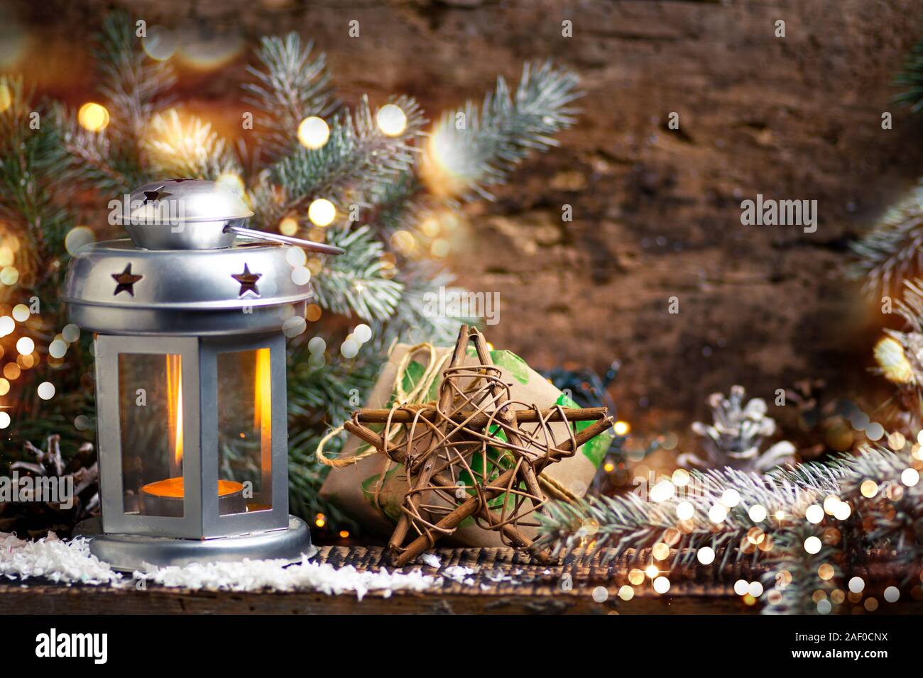 Festive lantern and Christmas decorations home arrangement with rustic background Stock Photo