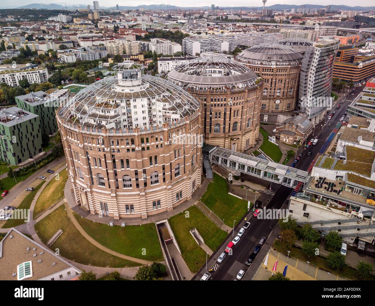 Aerial drone shot of Old Gasometer buidlings in Vienna from above. Used  like gasholders, it is music hall, museum, dormitory and shopping center  howad Stock Photo - Alamy