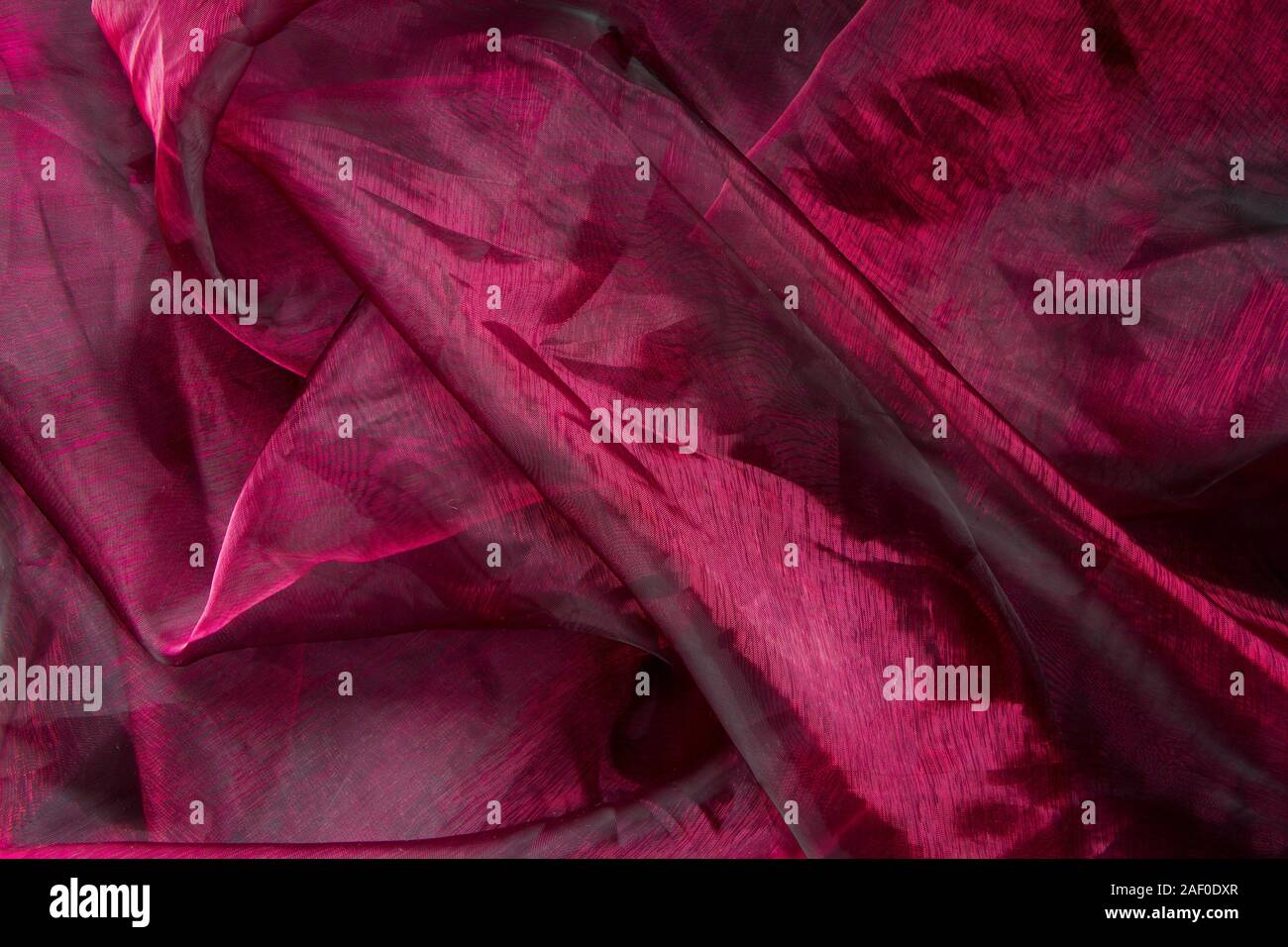 Background fabric folds lilac pink tulle or organza, selective focus Stock Photo