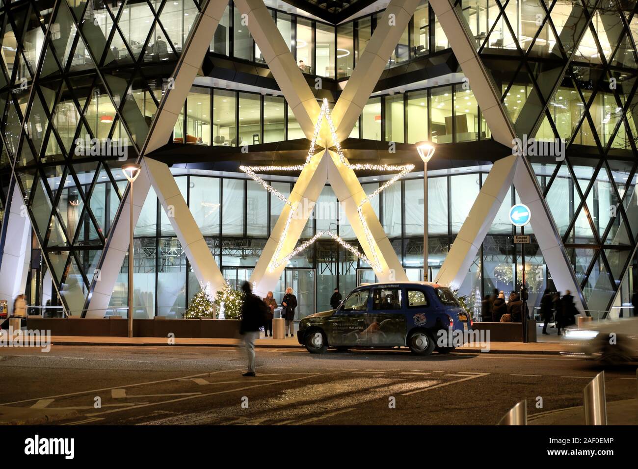 Christmas trees and star decoration outside the entrance to the gherkin skyscraper building in the financial district City of London UK  KATHY DEWITTf Stock Photo