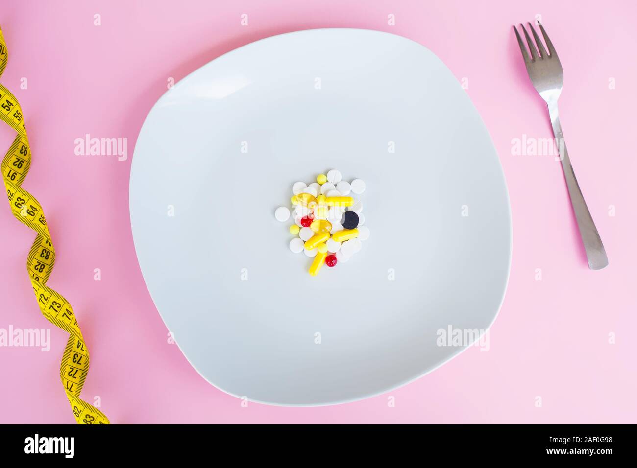 Medical Concept. Colored Pills And Capsule On Plate With Fork. Pharmacy
