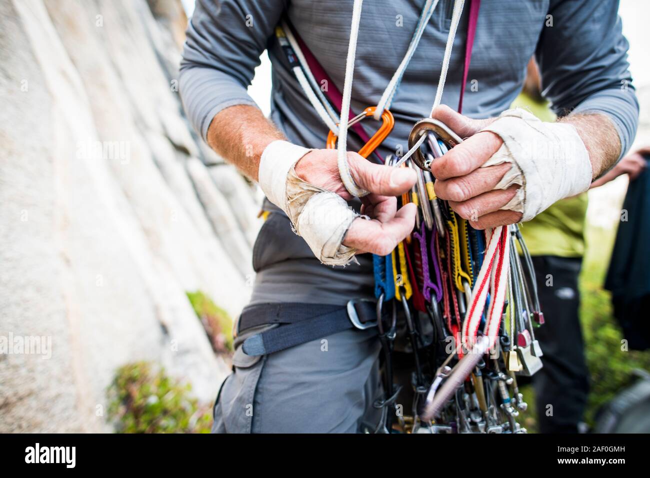 Rugged climber hands sorting through climbing gear Stock Photo Alamy
