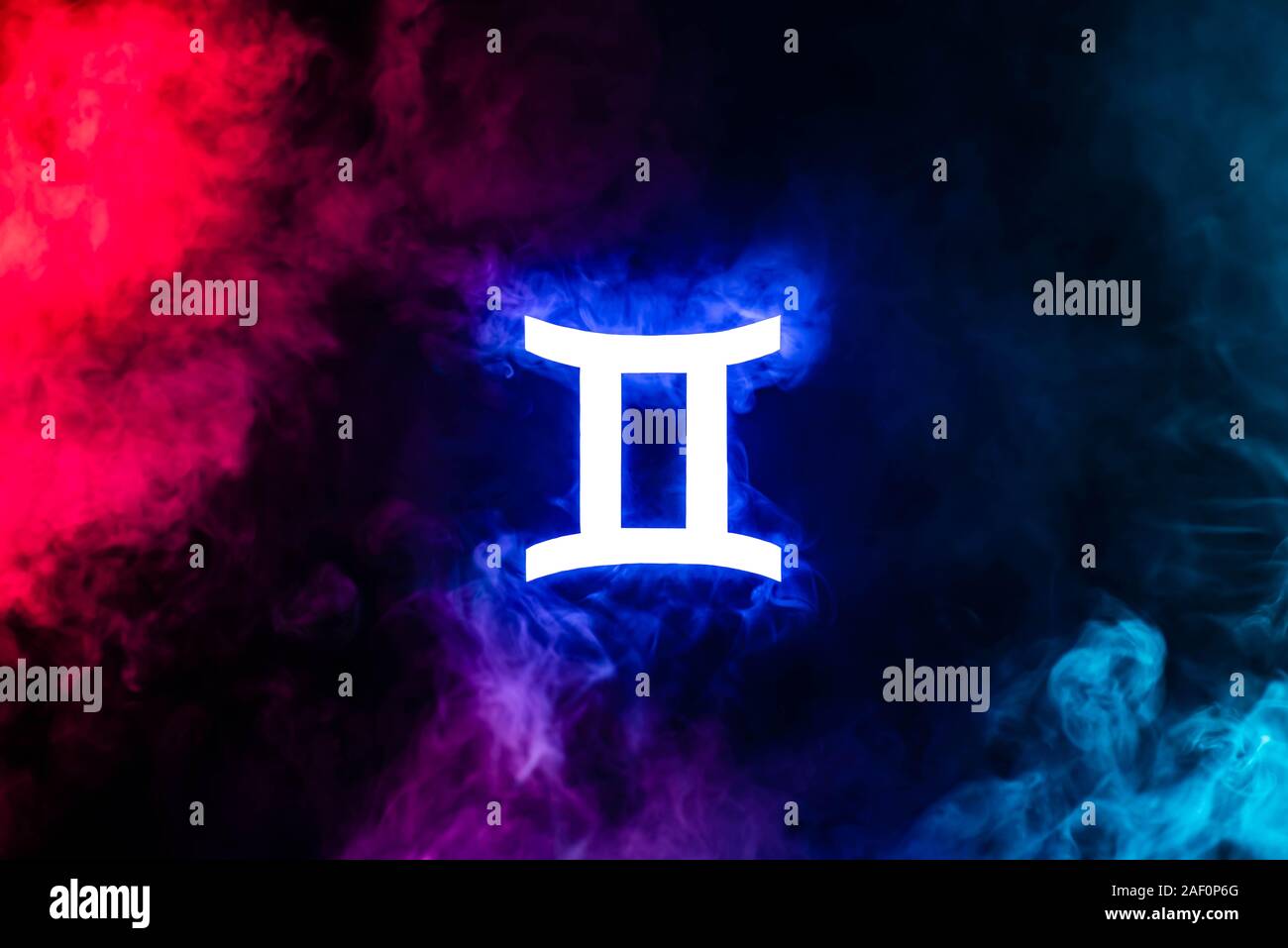 blue illuminated Gemini zodiac sign with colorful smoke on background ...