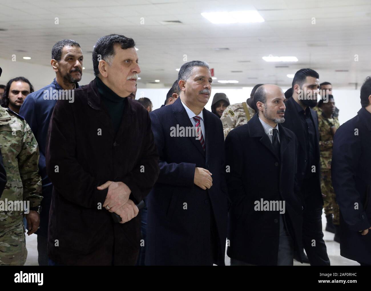 Tripoli, Libya. 11th Dec, 2019. Libya's UN-backed Prime Minister Fayez Serraj (1st L, front) inspects the Mitiga International Airport in Tripoli, Libya, Dec. 11, 2019. The Mitiga International Airport in Tripoli will resume flights on Thursday. The airport has been closed in September after it was hit by shelling, and all flights have since been redirected to the International Airport of Misurata city, some 200 km east of Tripoli. Credit: Hamza Turkia/Xinhua/Alamy Live News Stock Photo