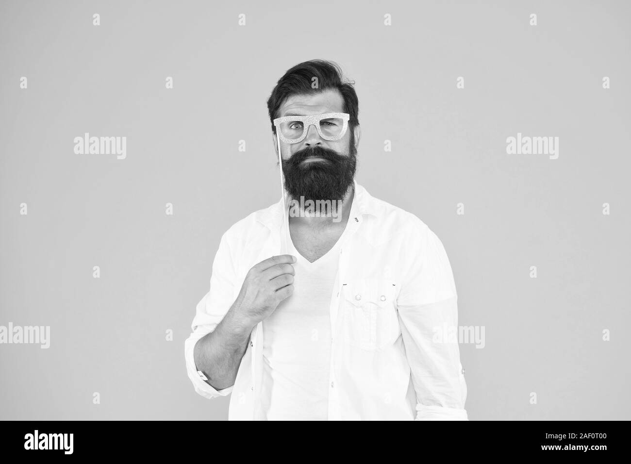 Photo Booth Prop Shaped Like Googlyeye Glasses Held Aloft Stock