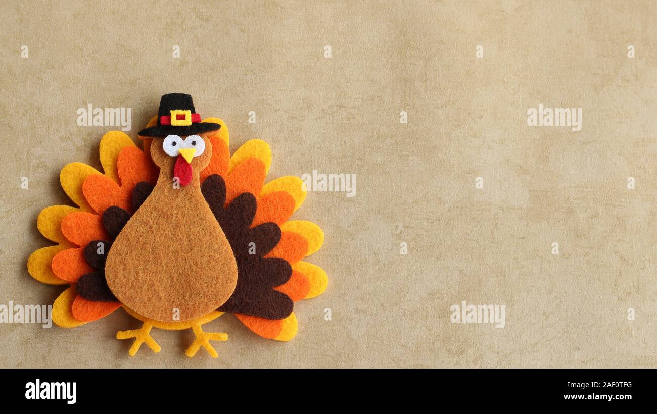 Craft felt turkey laying on a tan background with writing space Stock Photo