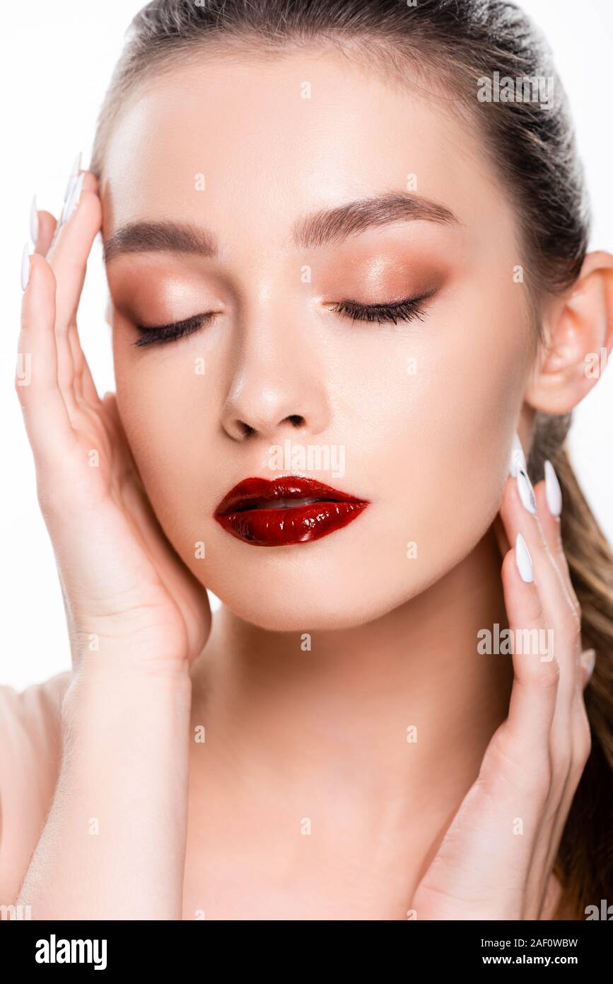 beautiful young woman touching face with closed eyes isolated on white ...