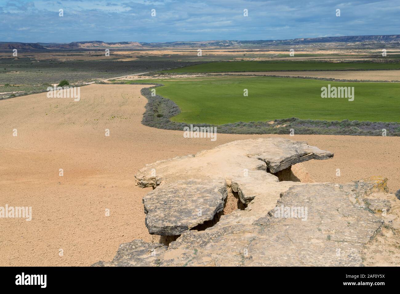 Flat-topped mountain above the plain with agricultural fields near the Spanish badlands Bardenas Reales Stock Photo